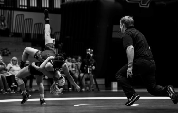   A member of the Women's Wrestling team takes on an opponent. 